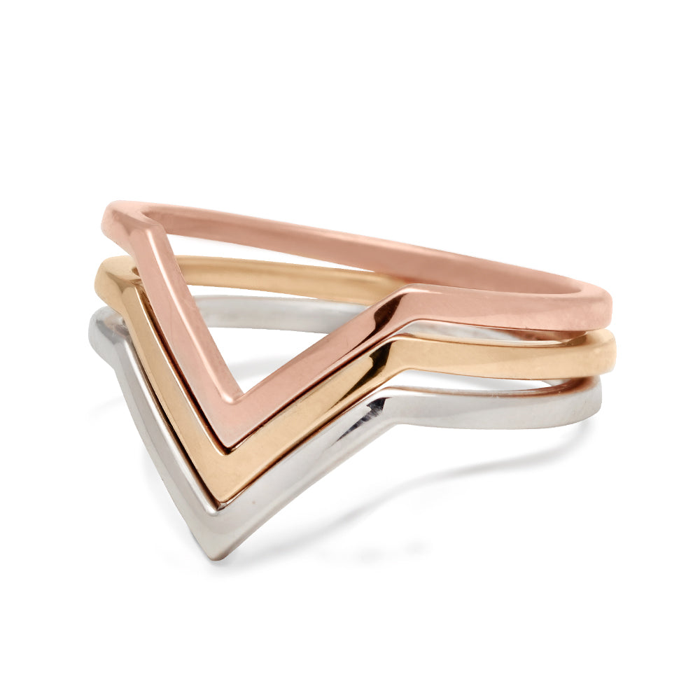 Three chevron shaped band in solid gold set in rose, yellow, and white gold.