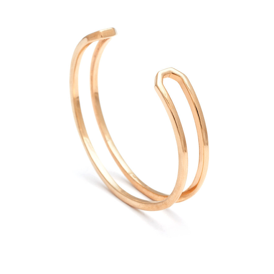 Side view of a doubled banded cuff bracelet set in yellow gold.