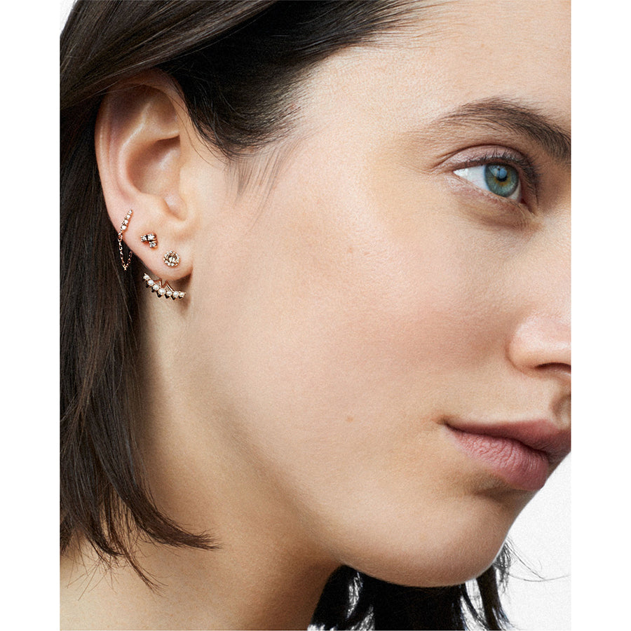 A light-complextion model with three stud earrings with diamonds., White Gold, Rose Gold, Yellow Gold