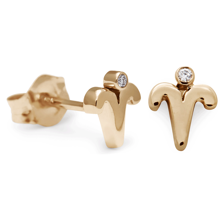 A pair of Aires stud earrings set in yellow gold with a white diamond accent stone with one earring angled.