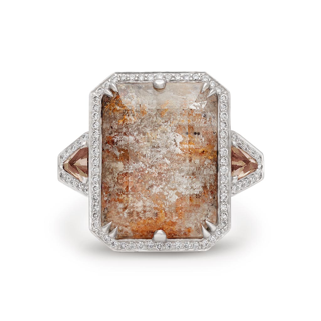A square dolomite center stone with andalusite trillion side stones and white diamond pave halo encircling it all set in white gold.