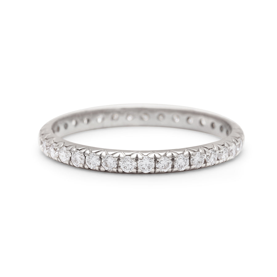 A white gold band with an eternity of round white diamond stones., White Gold