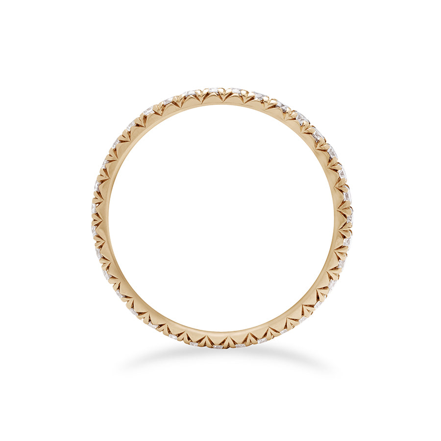 Side view of a yellow gold band with an eternity of round white diamond stones.