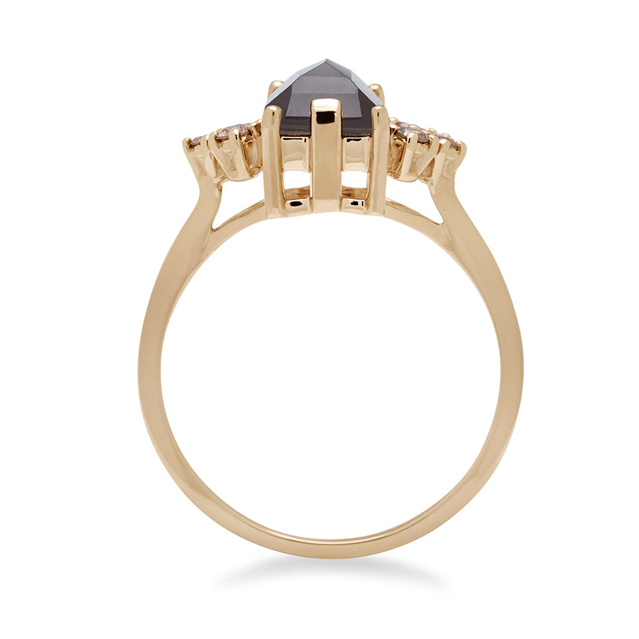 Side view of a ring with an emerald cut grey moonstone center with three round champagne diamonds on either side in arrow shape, set in yellow gold.