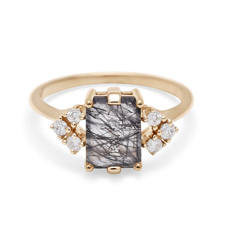 A ring with an emerald cut black rutilated quartz center with three round white diamonds on either side in arrow shape, set in yellow gold., Yellow Gold