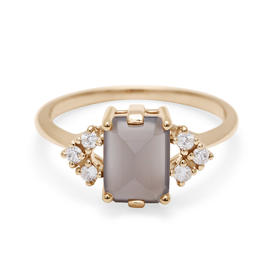 A ring with an emerald cut grey moonstone center with three round white diamonds on either side in arrow shape, set in yellow gold., Yellow Gold