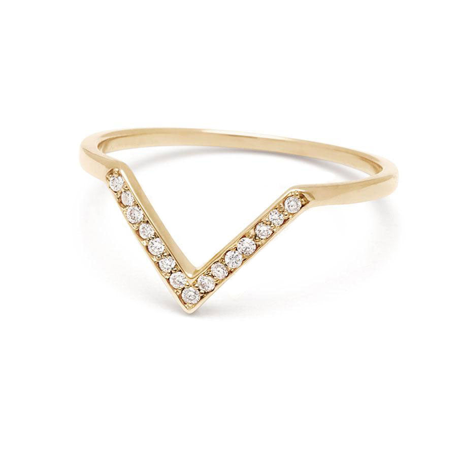 Angled view of a band with 9 round white diamonds set in yellow gold.