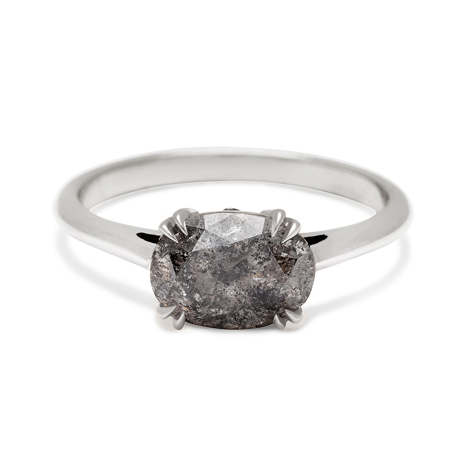 An east/west solitaire ring with an oval grey diamond stone set in white gold., White Gold