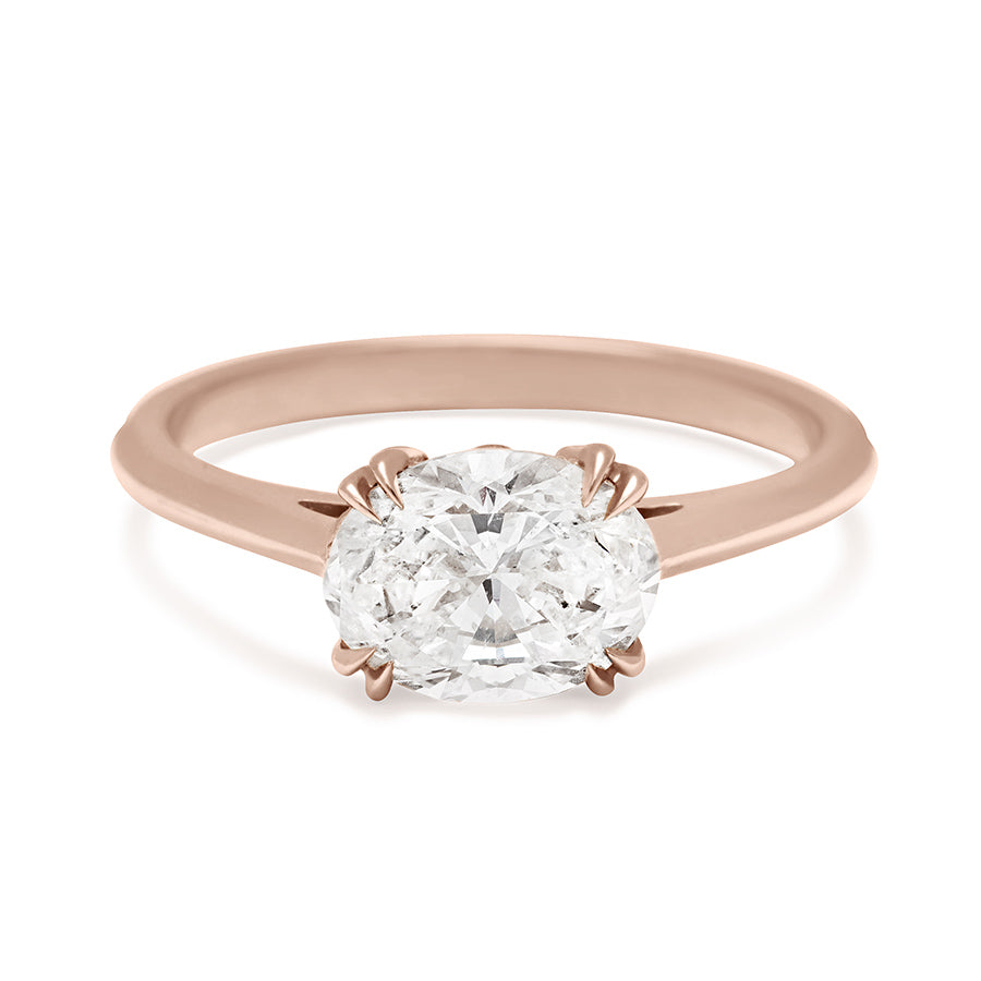 An east/west solitaire ring with an oval brilliant cut white diamond stone set in rose gold., Rose Gold