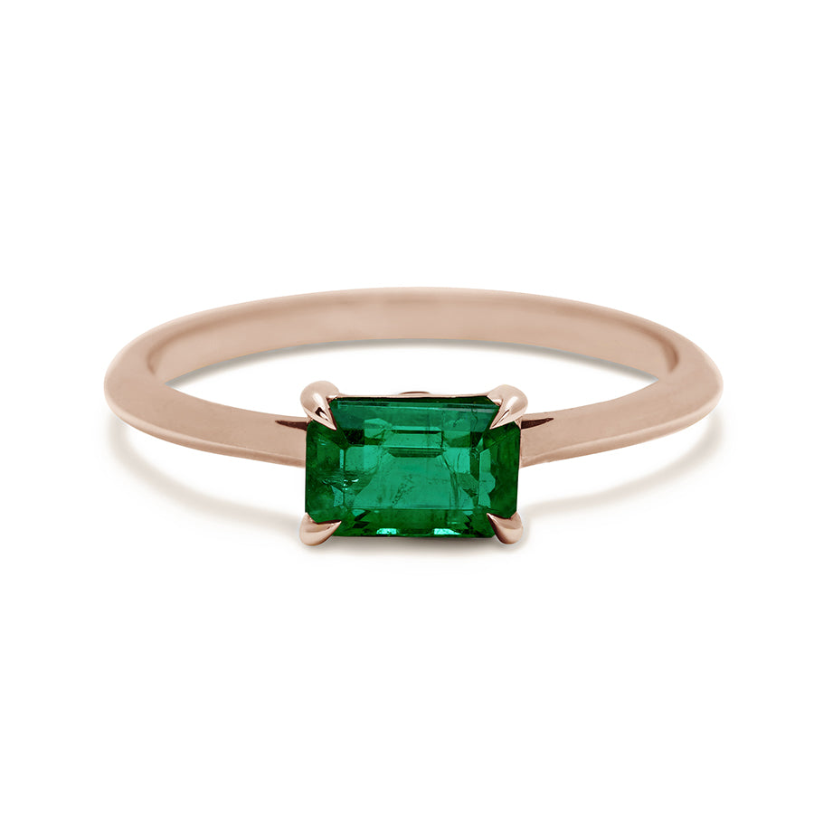 An east/west solitaire ring with an emerald shape green emerald stone set in rose gold., Rose Gold