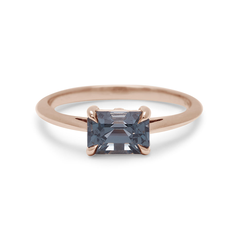 An east/west solitaire ring with an emerald shape grey spinel stone set in rose gold., Rose Gold