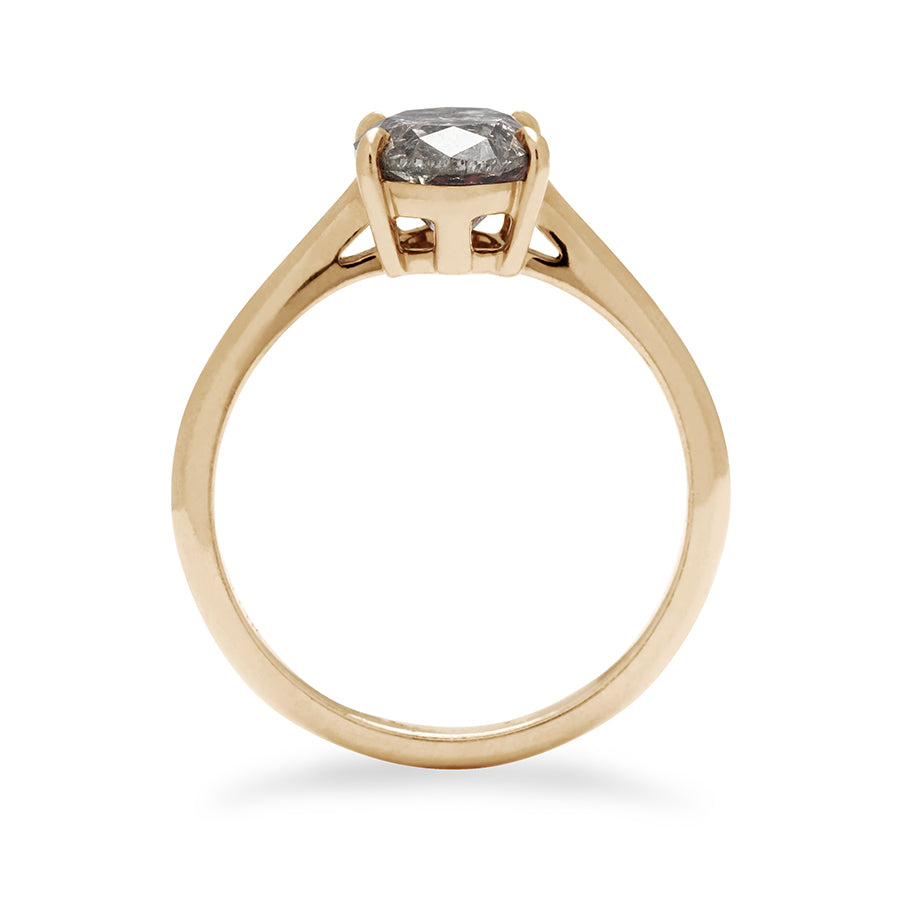 A side view of a solitaire ring oval grey diamond set in yellow gold.