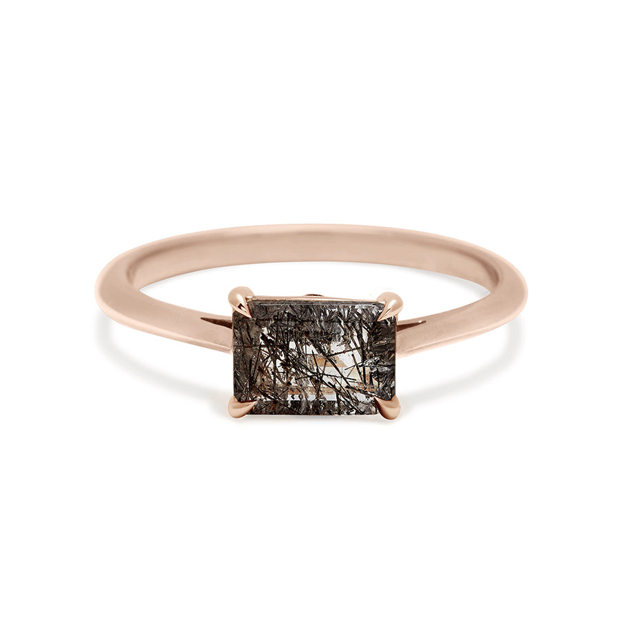 An east/west solitaire ring with an emerald shape black rutilated quartz stone set in rose gold., Rose Gold