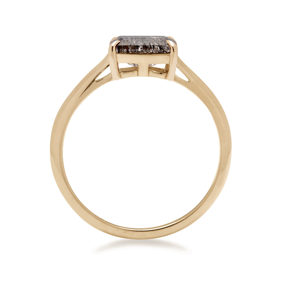 A side view of an east/west solitaire ring with an emerald shape black rutilated quartz stone set in yellow gold., Yellow Gold