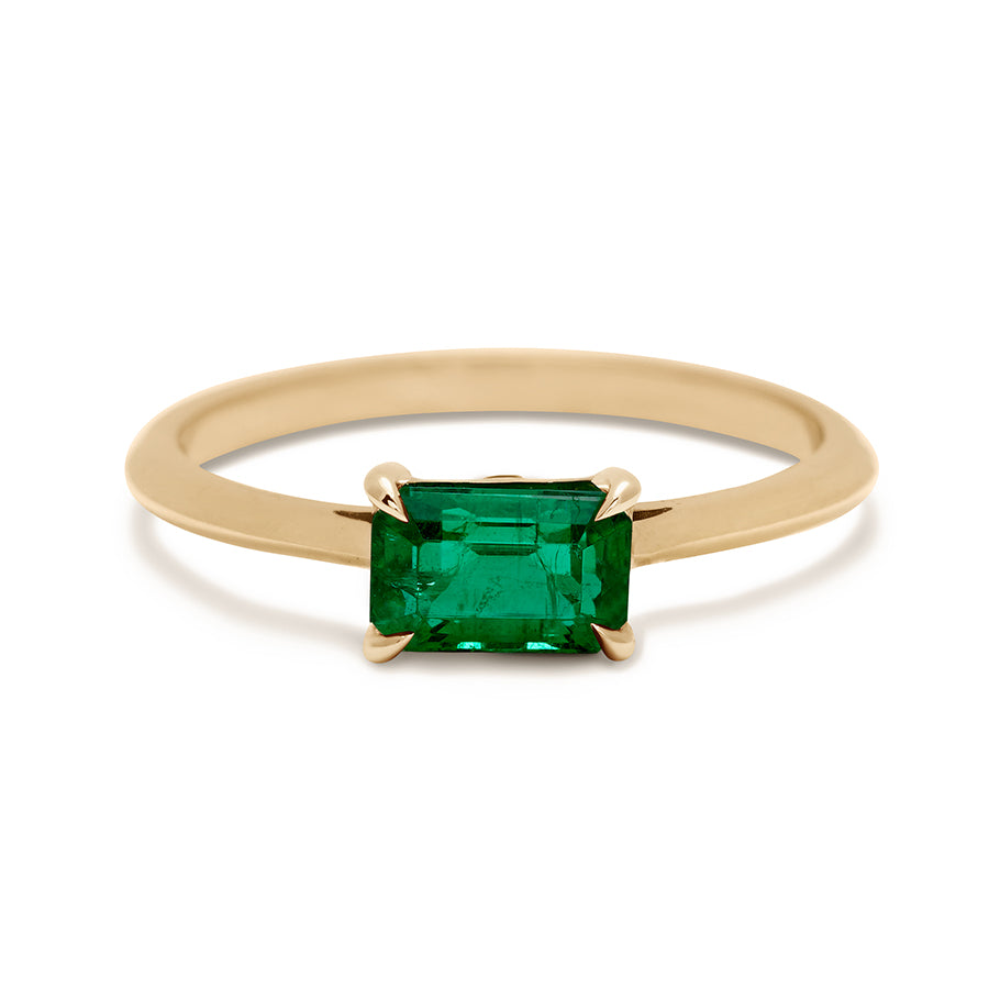 An east/west solitaire ring with an emerald shape green emerald stone set in yellow gold., Yellow Gold