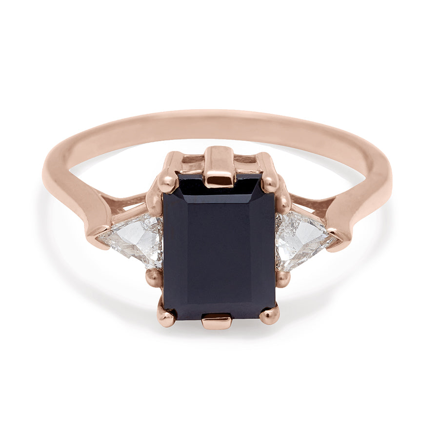 A three stone engagement ring with an emerald cut and emerald shape 8x6mm black diamond center stone with two white diamond trillion side stones set in rose gold., Rose Gold