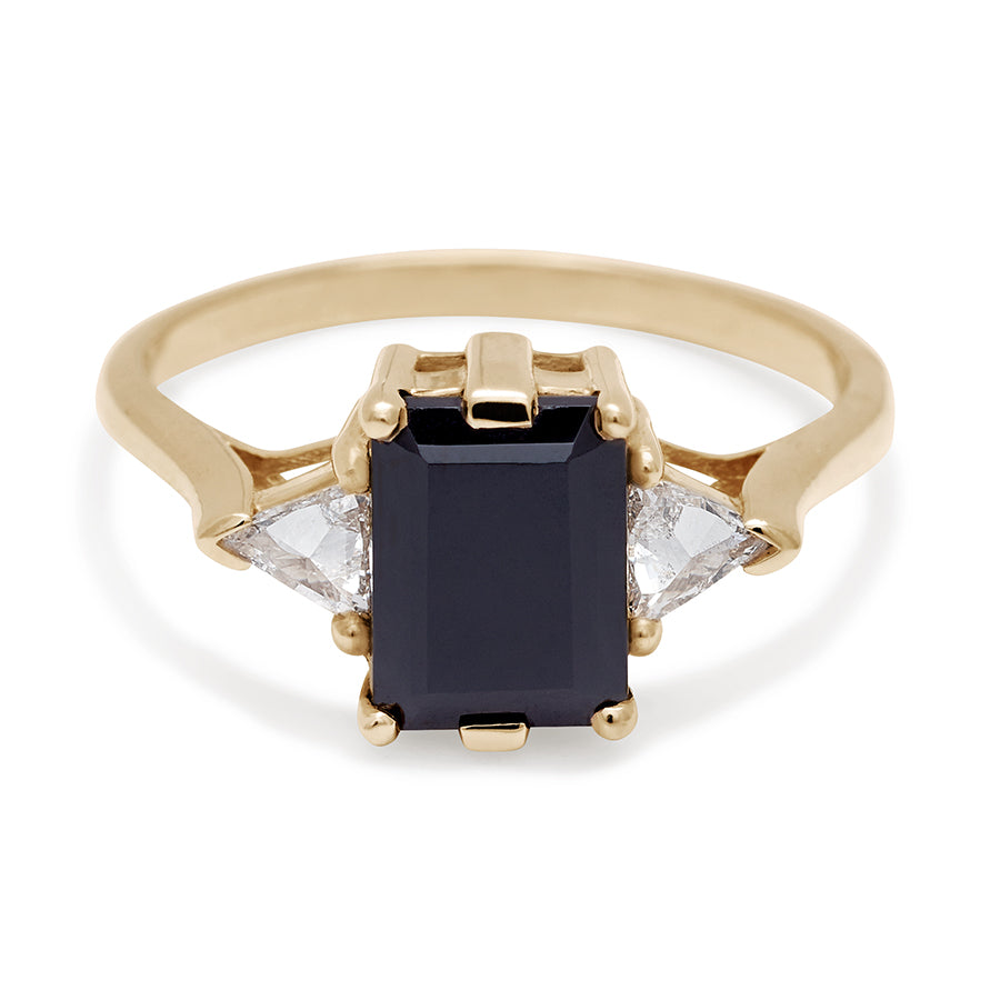 A three stone engagement ring with an emerald cut and emerald shape 8x6mm black diamond center stone with two white diamond trillion side stones set in yellow gold., Yellow Gold