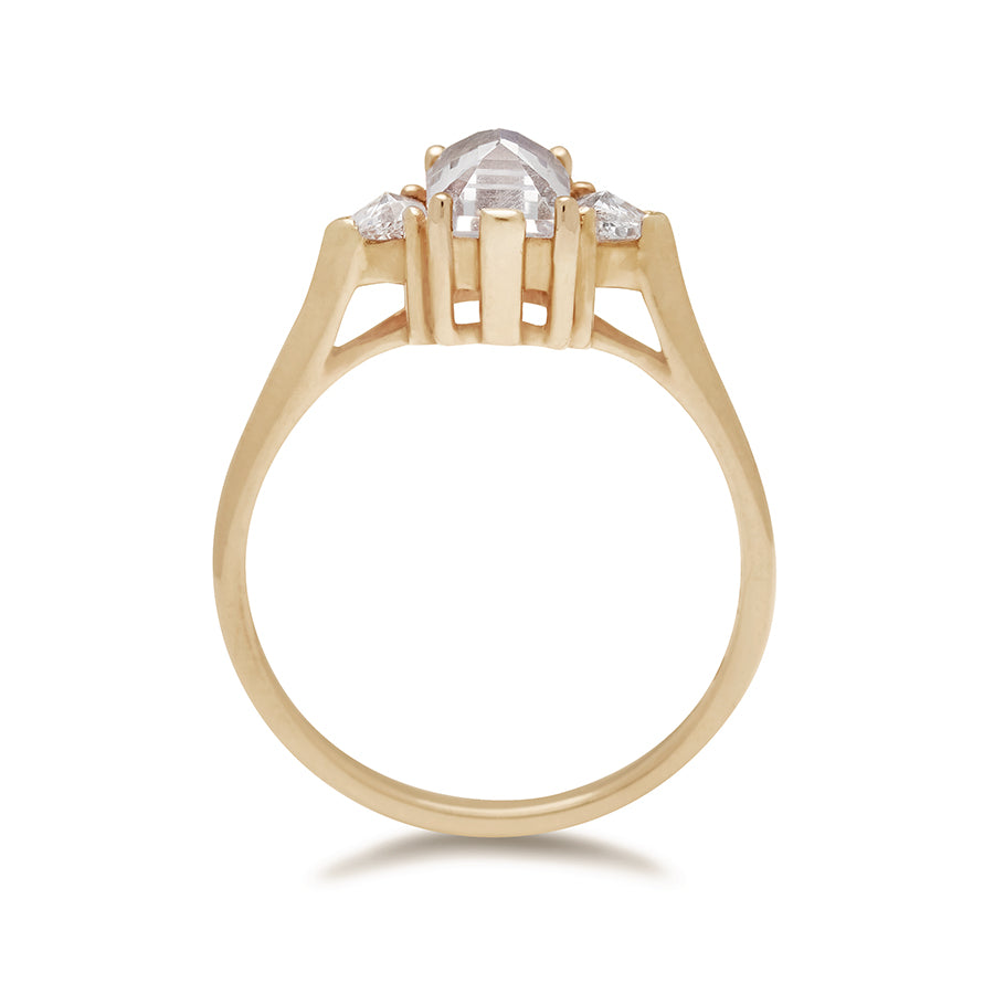 Side view of a three stone engagement ring with an emerald cut and emerald shape 7x5mm rainbow moonstone center stone with two white diamond trillion side stones set in yellow gold., Yellow Gold