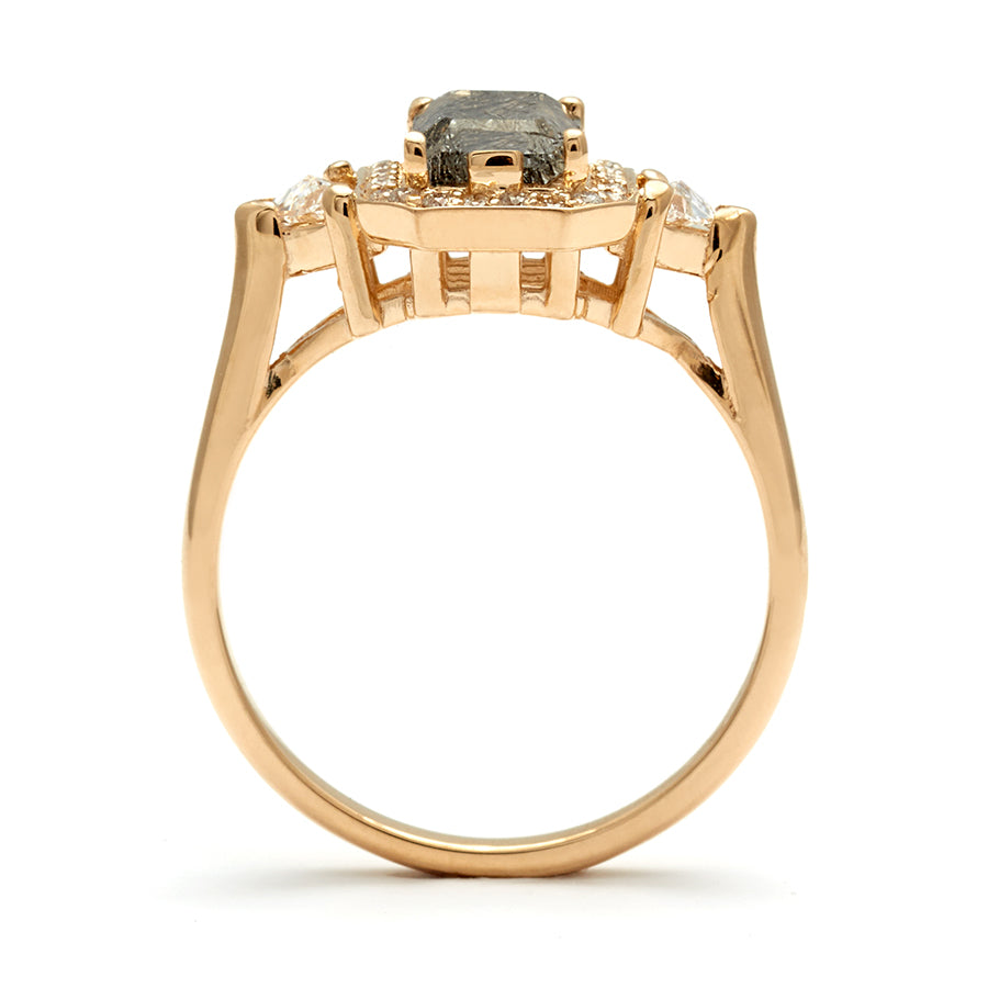 Side view of a three stone engagement ring with an emerald cut and emerald shape black rutilated quartz center stone surrounded by a white diamond pave halo with two white diamond trillion side stones set in yellow gold., Yellow Gold