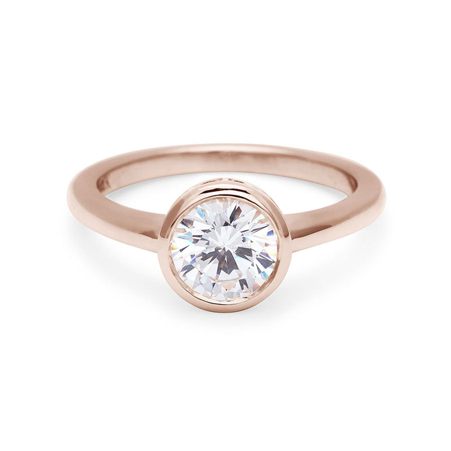 A round brilliant cut bezel set white diamond set in rose gold., Rose Gold