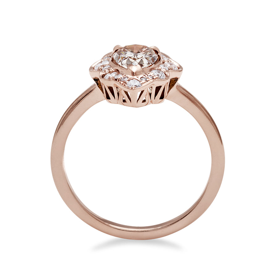 A side view of a pear shaped champagne diamond ring set in a halo of white diamonds and in rose gold., Rose Gold, Yellow Gold
