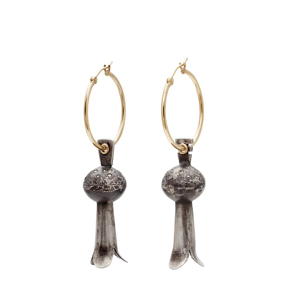 A pair of yellow gold hoops with sterling silver squash blossom charm drop portions.
