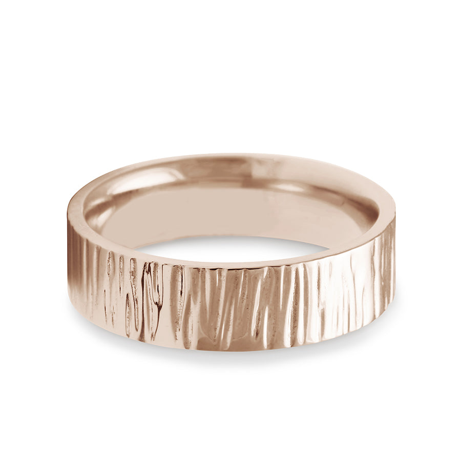 A comfort fit solid gold band with birch engraving on the outside set in rose gold., Rose Gold