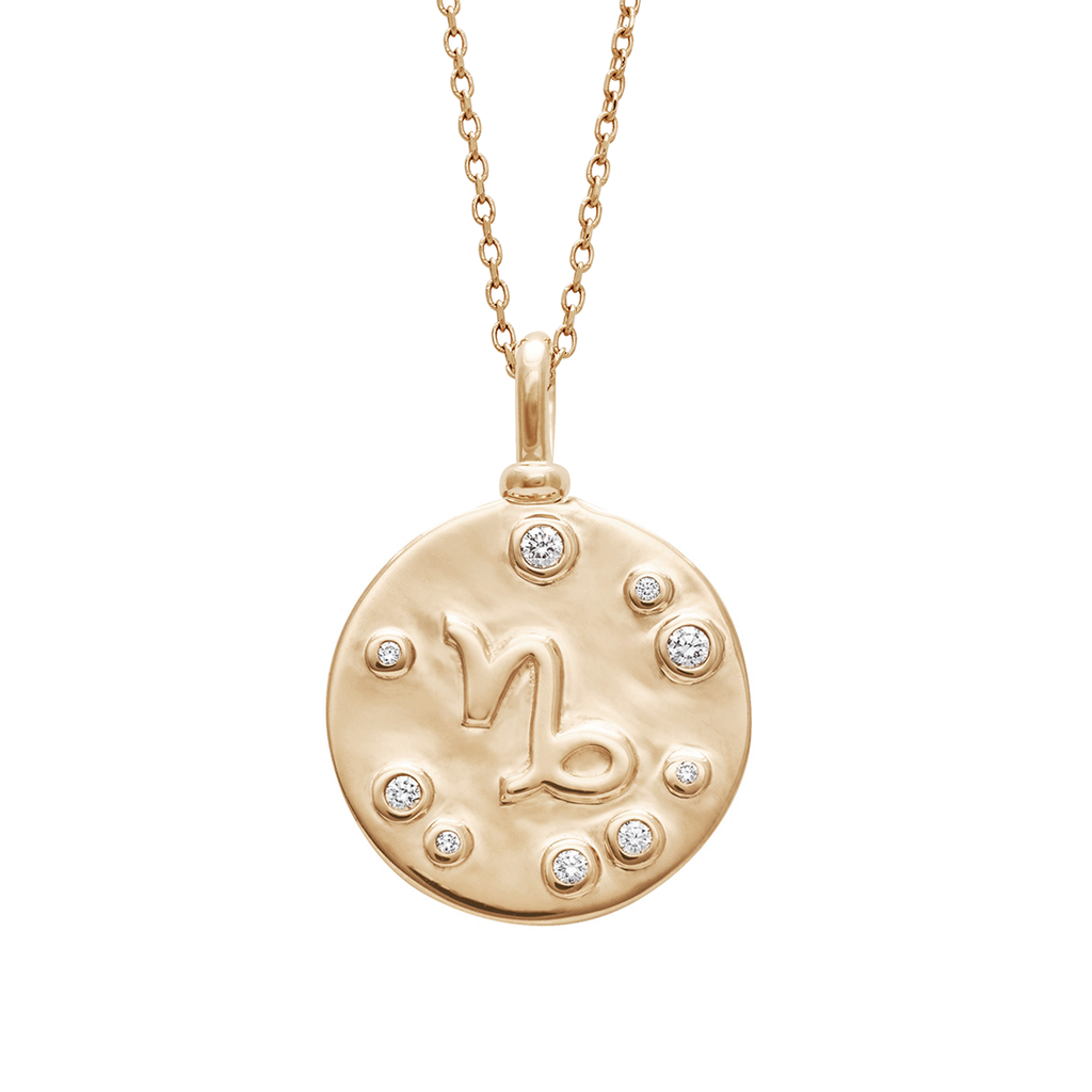 A 18mm charm with the Capricorn zodiac sign with white diamond stones set in yellow gold on a yellow gold chain.