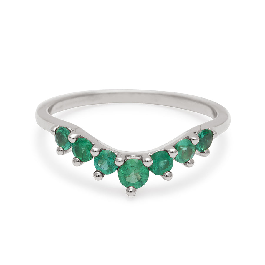A curved 7 emerald band set in white gold., White Gold