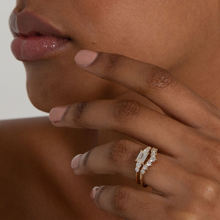 Female hand wearing Cosmic Tiara Curve Band - 14k Gold & Emerald