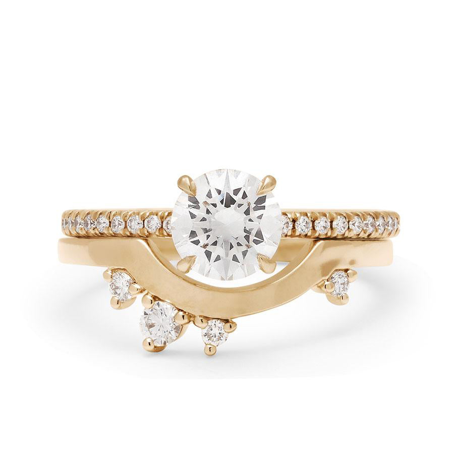 A solitaire round white diamond ring with claw prongs with white diamond pave on the band set in yellow gold set above an asymmetrical white diamond yellow gold band., White Gold, Rose Gold, Yellow Gold