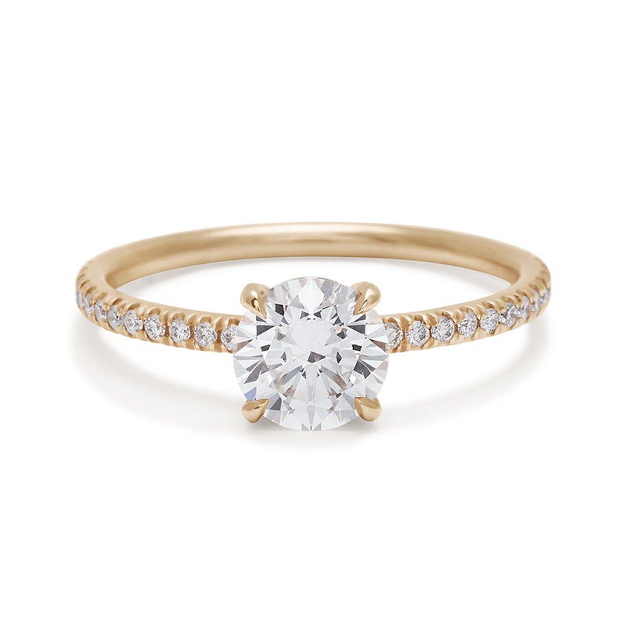 A solitaire round white diamond ring with double claw prongs with white diamond pave on the band set in yellow gold., Yellow Gold