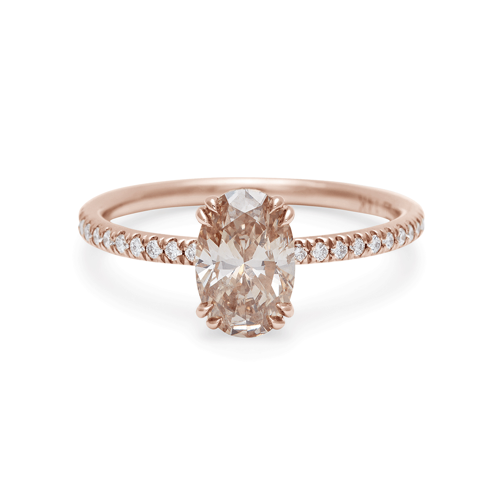 A solitaire oval champagne diamond ring with double claw prongs with white diamond pave on the band set in rose gold., Rose Gold