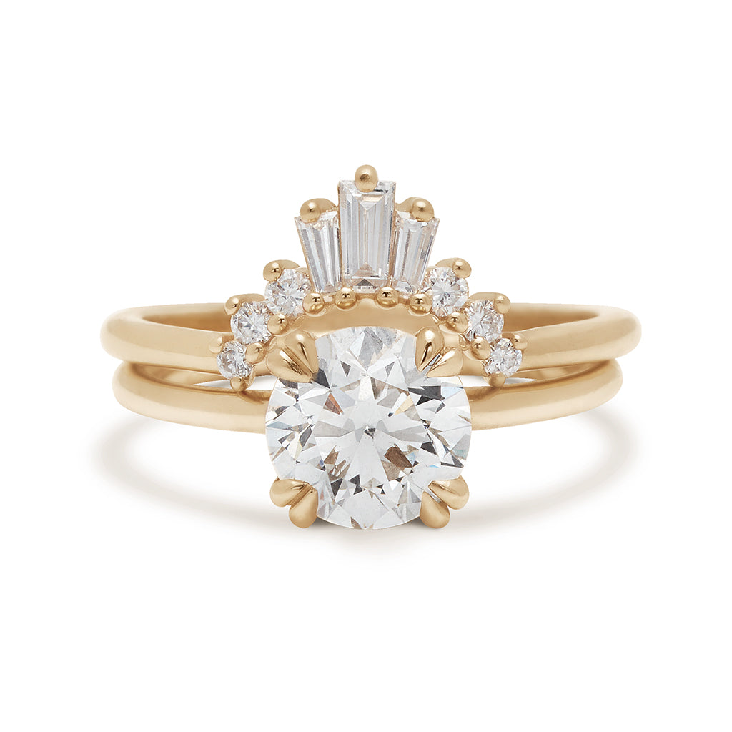 A solitaire round 1.25ct white diamond ring with double claw prongs set in yellow gold above a triple baguette white diamond band in yellow gold., White Gold, Rose Gold, Yellow Gold
