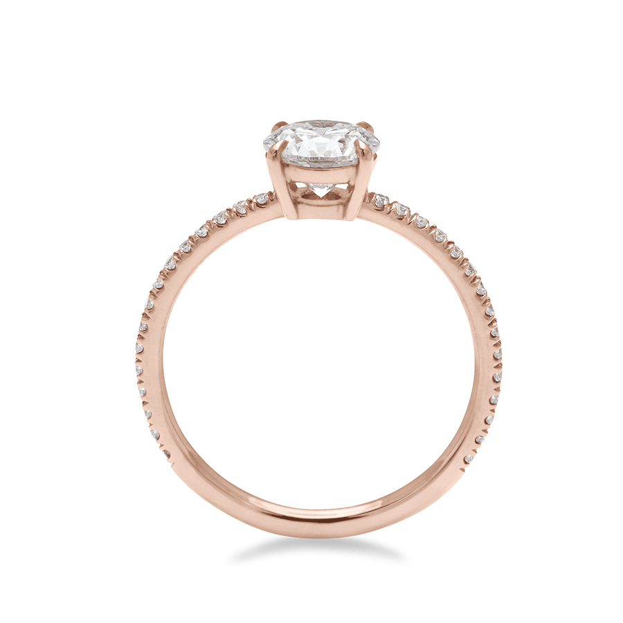 Side view of a solitaire round white diamond ring with double claw prongs with white diamond pave on the band set in rose gold., Rose Gold