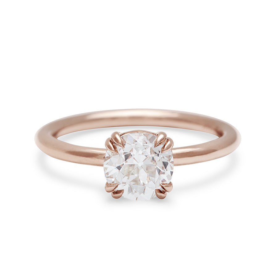 A solitaire round 1.41ct white diamond ring with double claw prongs set in rose gold.