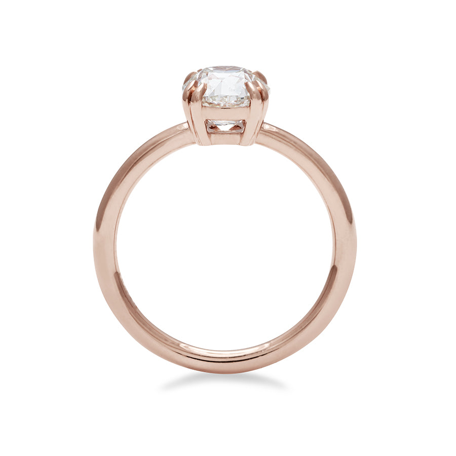 Side view of a solitaire round 1.41ct white diamond ring with double claw prongs set in rose gold.