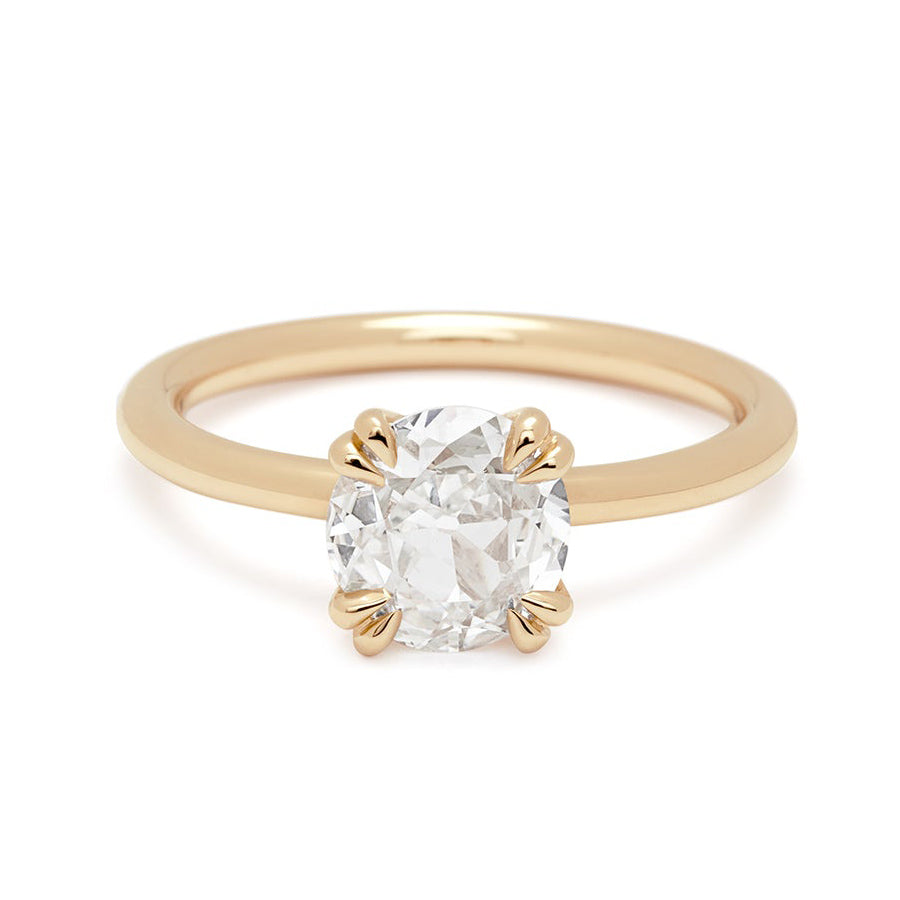 A solitaire round 1.20ct white diamond ring with double claw prongs set in yellow gold.