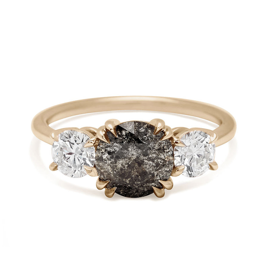 A three stone engagement ring with a round shape grey diamond center stone with two white diamond round side stones set in yellow gold., Yellow Gold