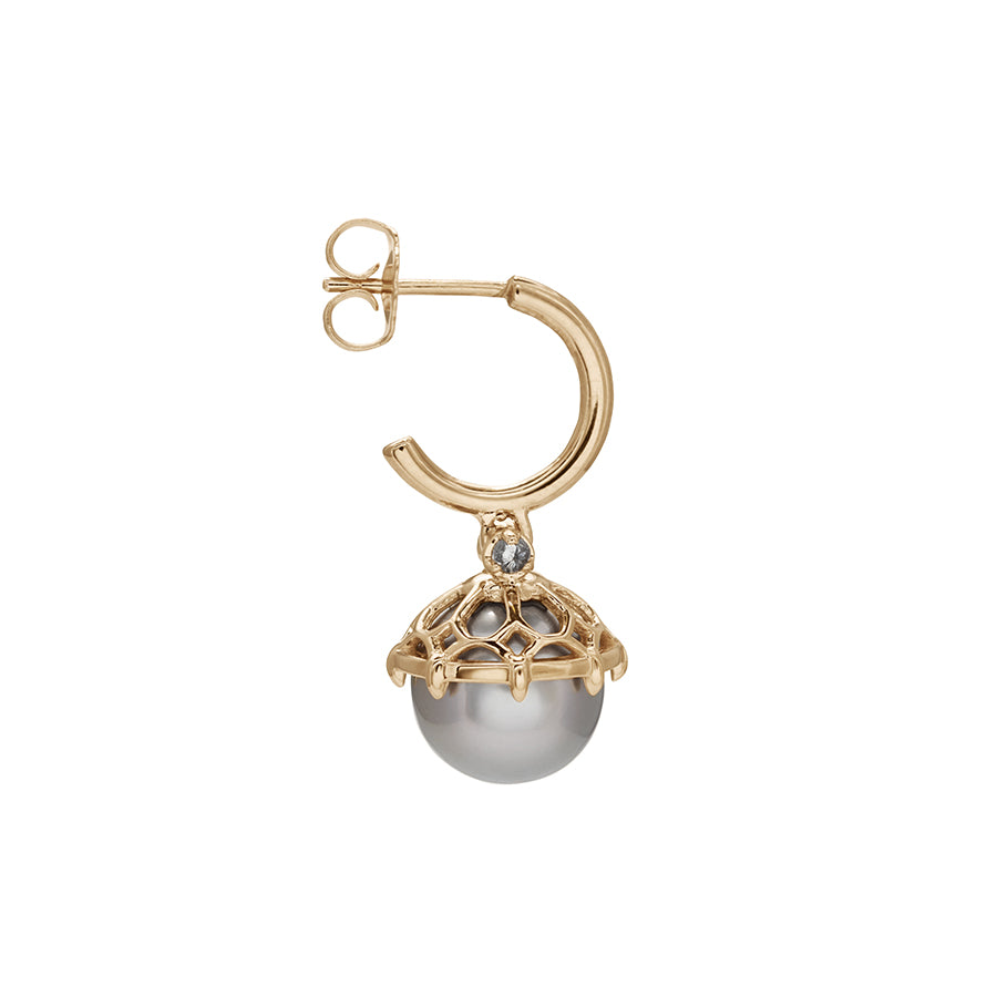 Side view of a single hoop with a light pearl hanging from it with grey diamond accents on either side set in yellow gold.