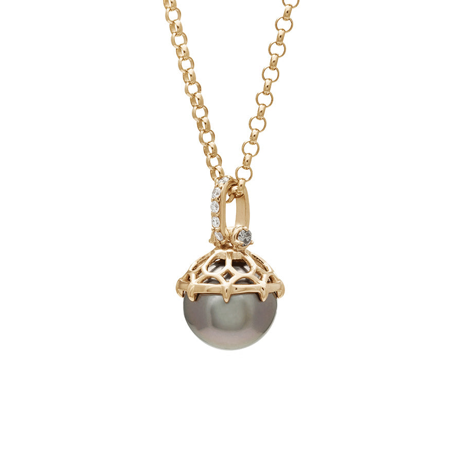 Angled view of a one of a kind peacock pearl pendant with white diamond pave on the top and grey diamond accent stones on either side on a yellow gold chain.