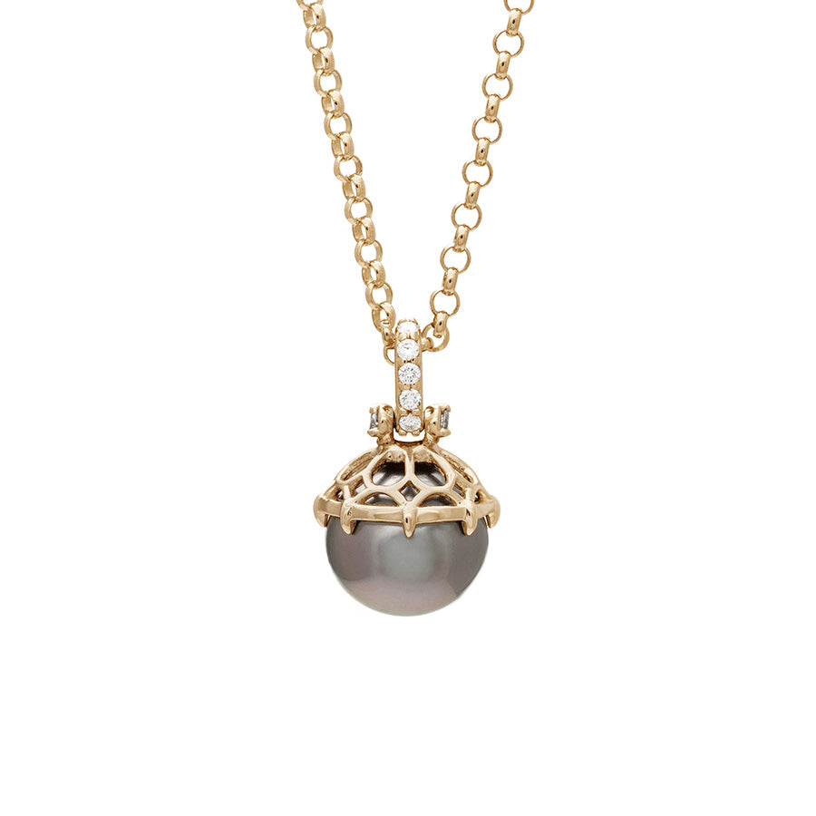 A one of a kind peacock pearl pendant with white diamond pave on the top and grey diamond accent stones on either side on a yellow gold chain.