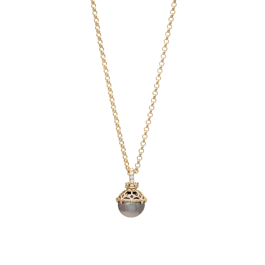 Zoomed out view of a one of a kind peacock pearl pendant with white diamond pave on the top and grey diamond accent stones on either side on a yellow gold chain.