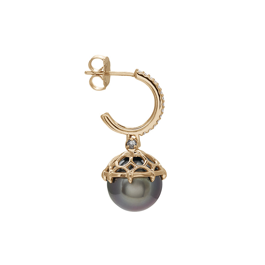 Side view a single white diamond hoop with a dark pearl hanging from it with grey diamond accents on either side set in yellow gold.