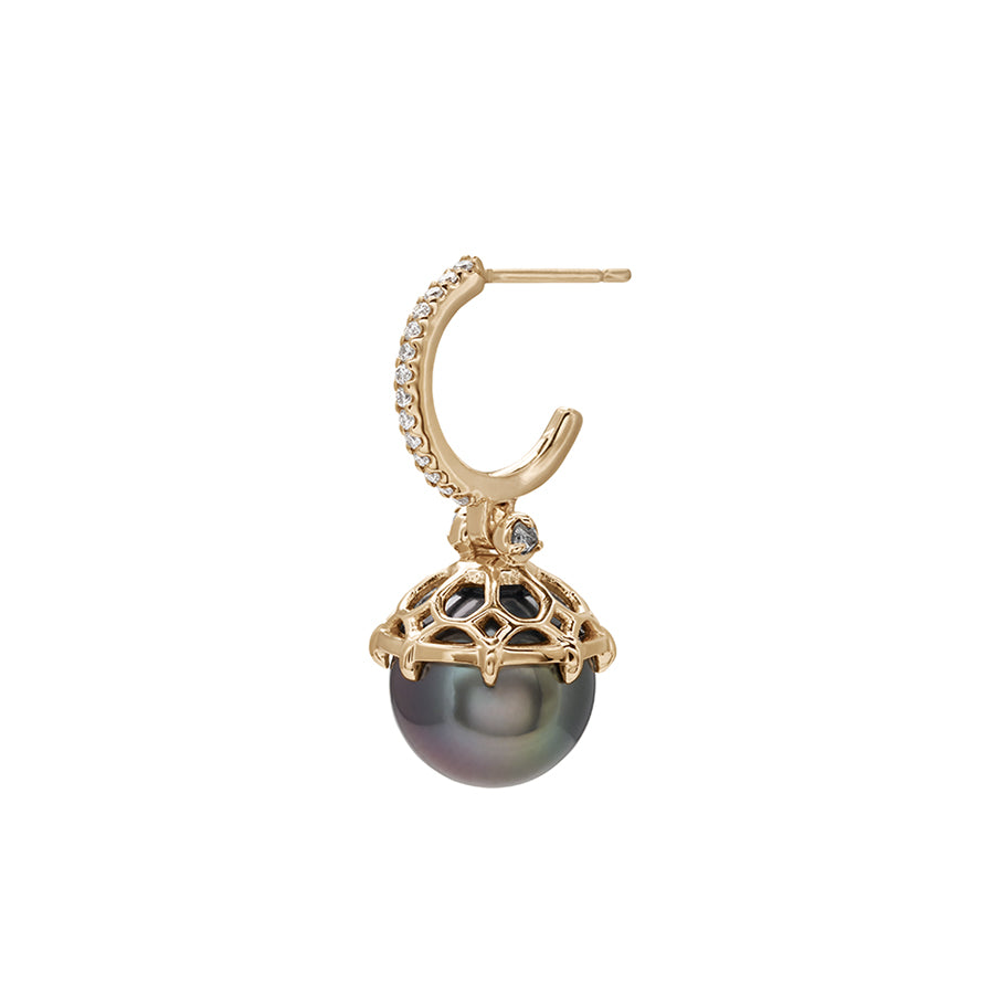 Angled view of a single white diamond hoop with a dark pearl hanging from it with grey diamond accents on either side set in yellow gold.