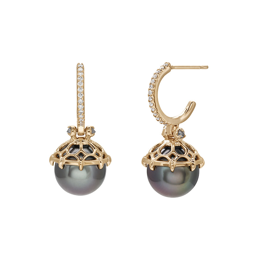 A pair of white diamond hoops with a dark pearl hanging from it with grey diamond accents on either side set in yellow gold.