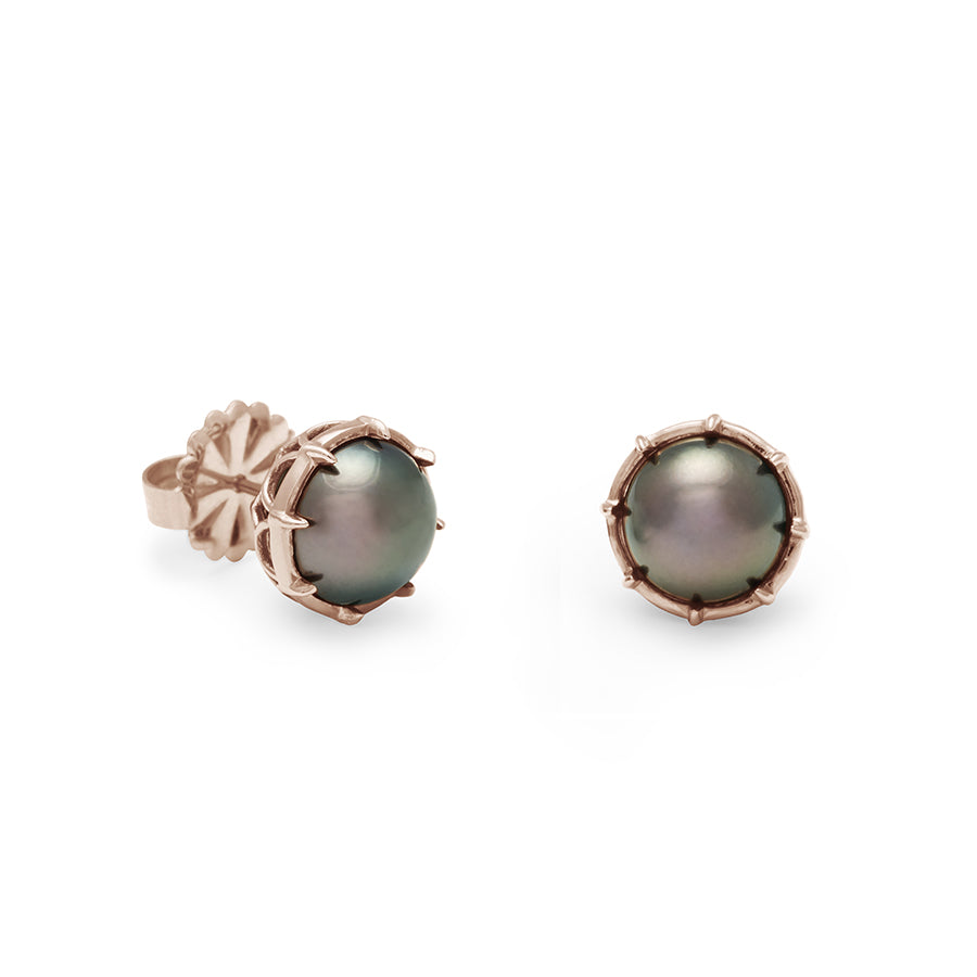 A pair of peacock pearl studs set in rose gold both angled