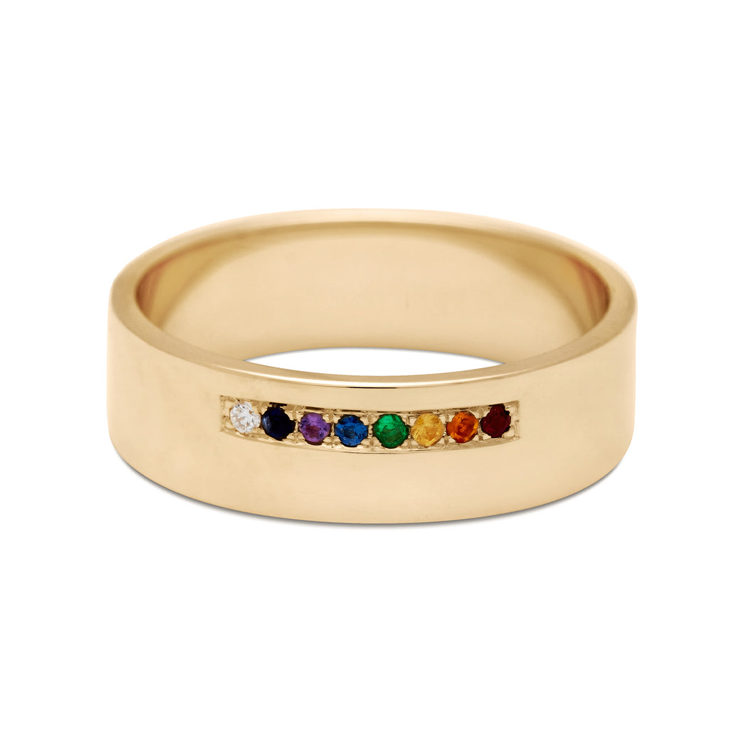 A 6mm flat band with a line of rainbow gemstone set in yellow gold.