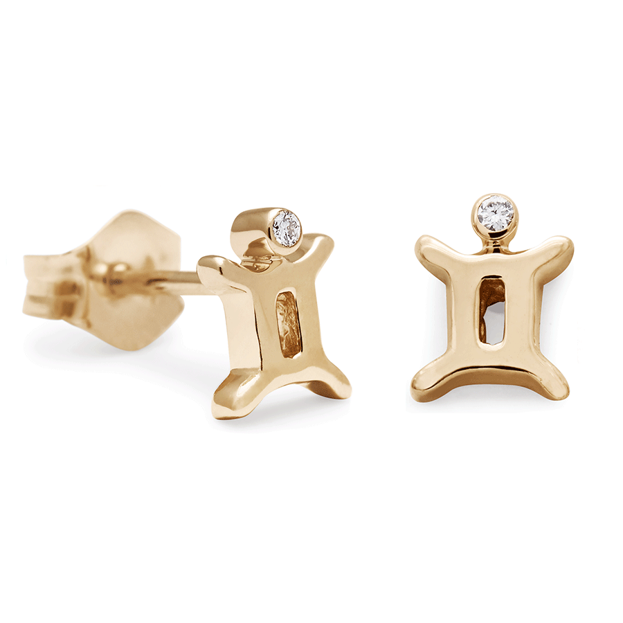 A pair of Gemini stud earrings set in yellow gold with a white diamond accent stone with one earring angled.