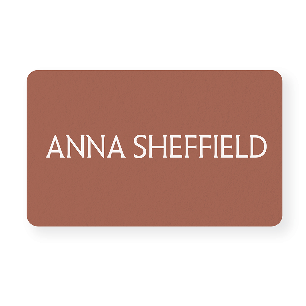 "Anna Sheffield" gift card on a adobe orange color rectangle.